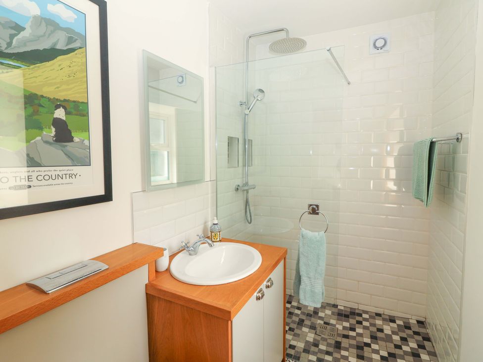 A bathroom with a shower and sink at Artist’s Cottage, Cashel, County Tipperary