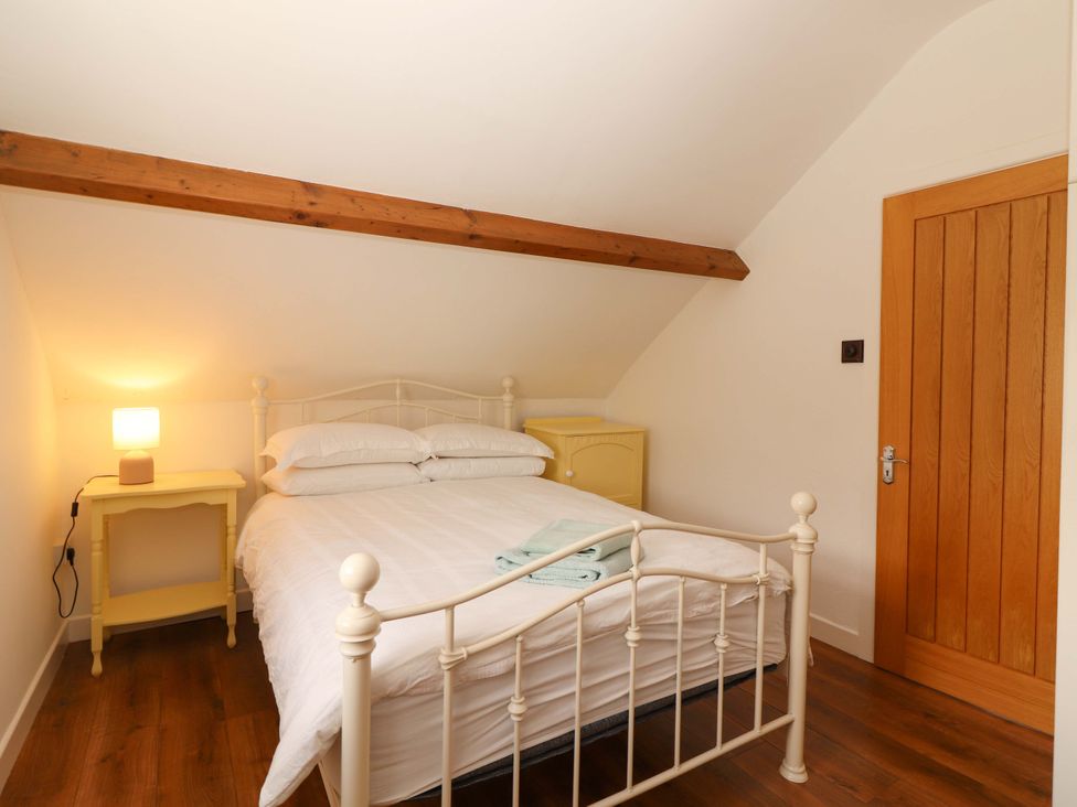 A bedroom with a bed and bedside table at Artist’s Cottage, Cashel, County Tipperary