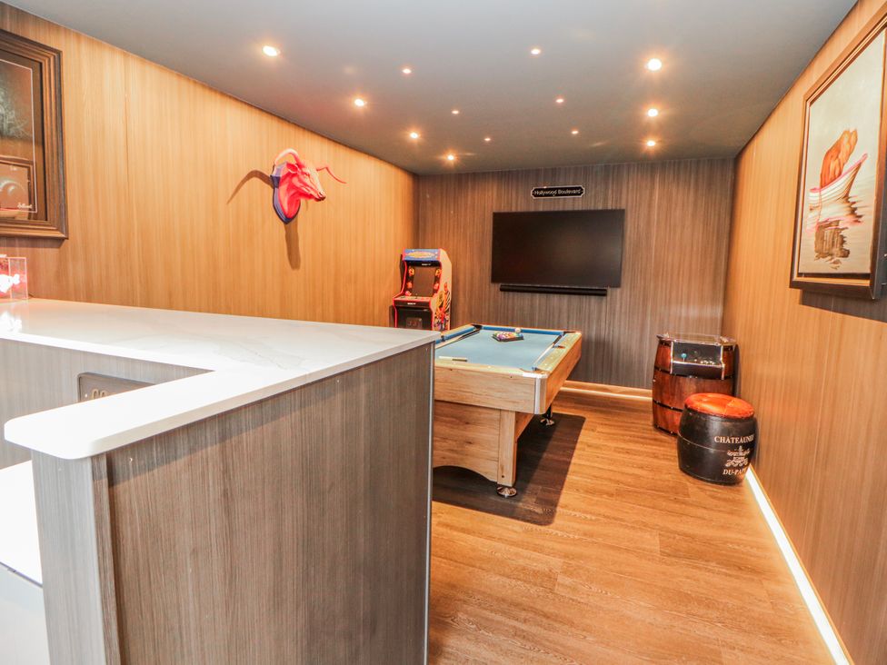 A snug with a snooker table and arcade machine at Bounty Boutique on the Lakes Bowness-On-Windermere