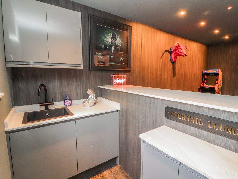 A bar with a sink and cupboard at Bounty Boutique on the Lakes, Bowness-On-Windermere