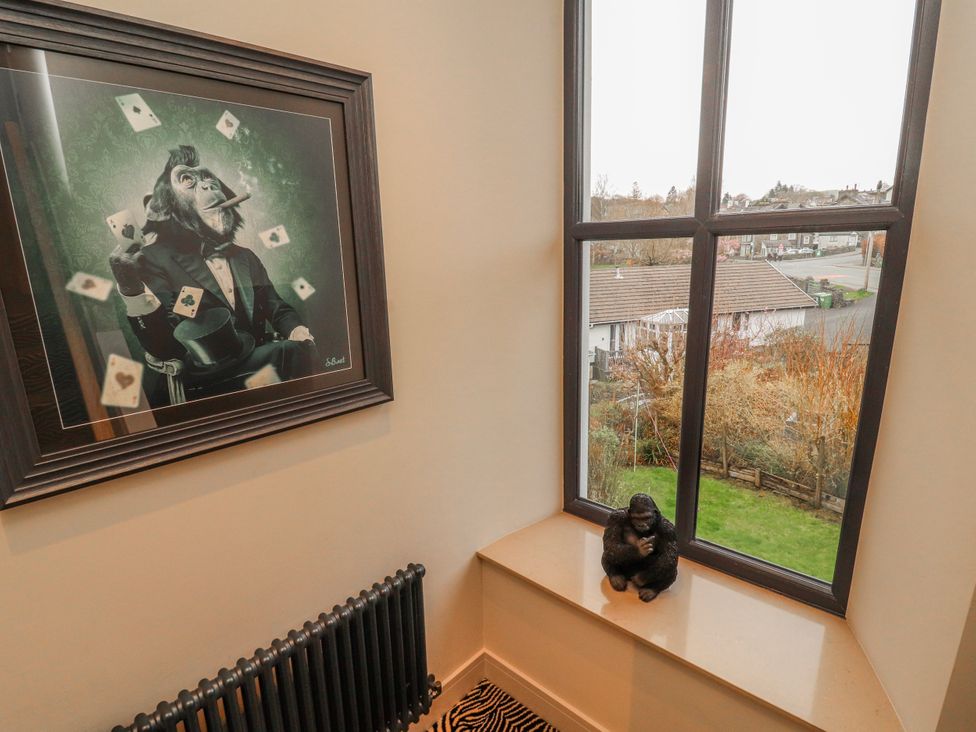 A staircase with a painting and a figurine at Bounty Boutique on the Lakes Bowness-On-Windermere