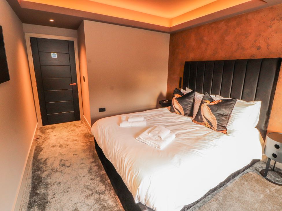 A bedroom with a bed and bedside table at Bounty Boutique on the Lakes Bowness-On-Windermere