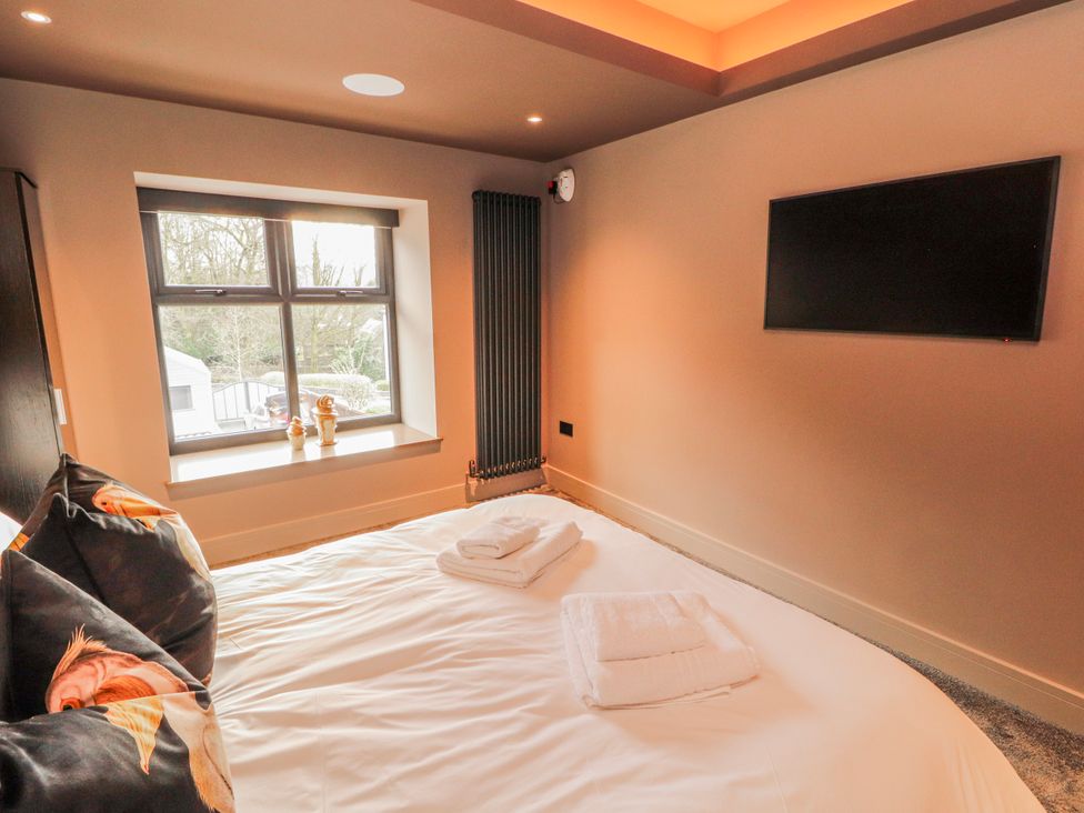 A bedroom with a bed and television at Bounty Boutique on the Lakes Bowness-On-Windermere