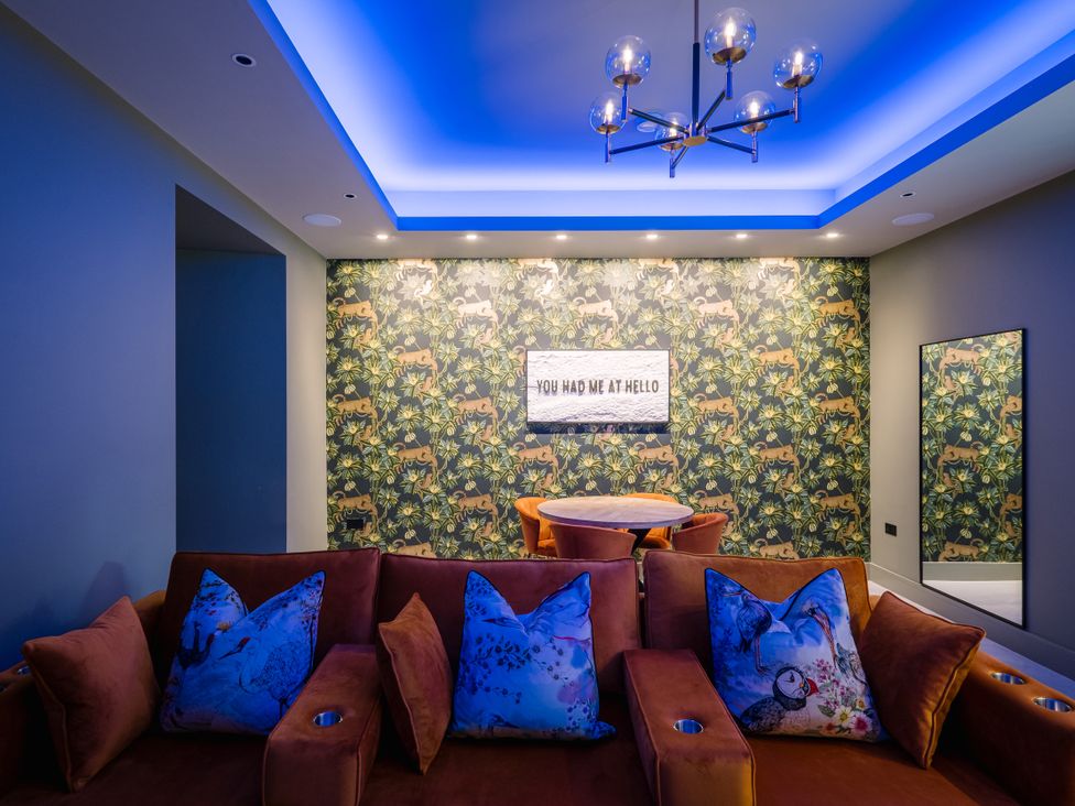 A living room with a couch and table at Bounty Boutique on the Lakes, Bowness-On-Windermere