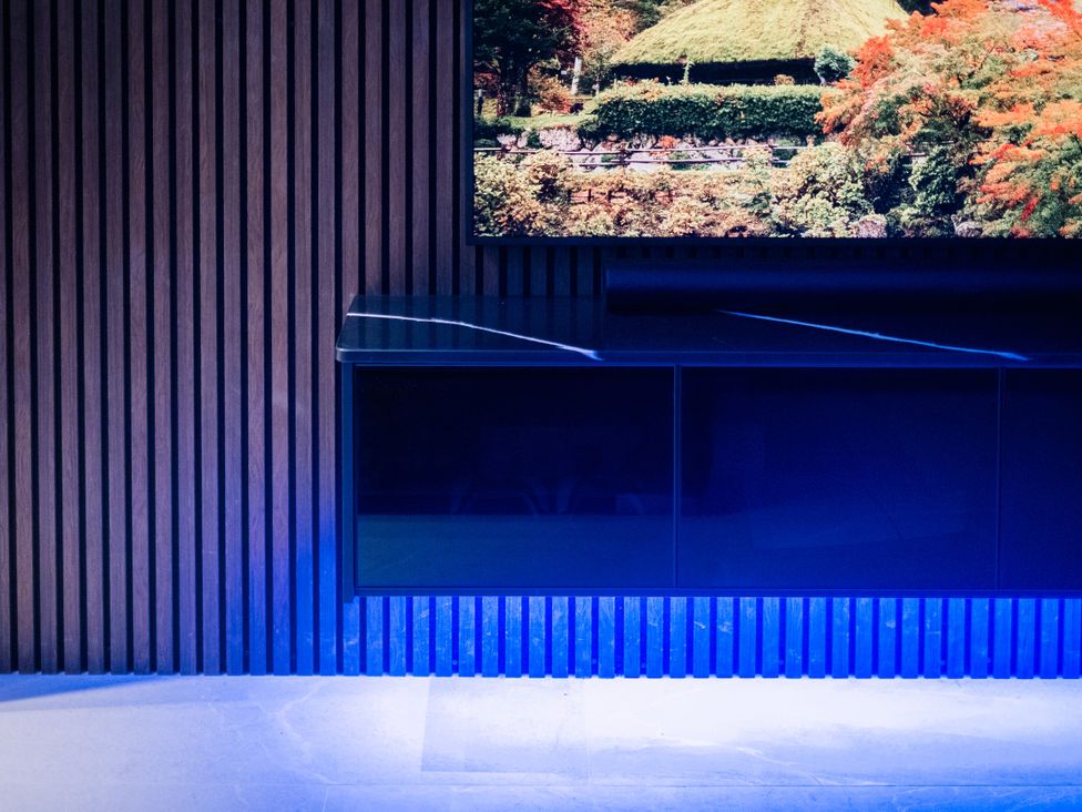 A living room with a television on a cabinet at Bounty Boutique on the Lakes, Bowness-On-Windermere