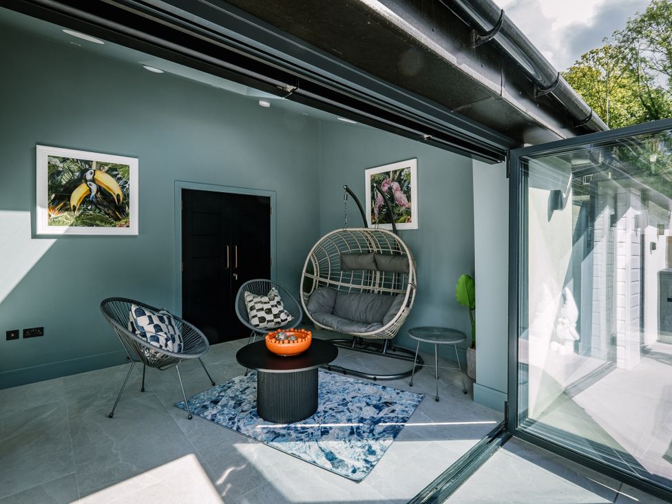 A sunroom with seating and artwork at Bounty Boutique on the Lakes in Bowness-On-Windermere