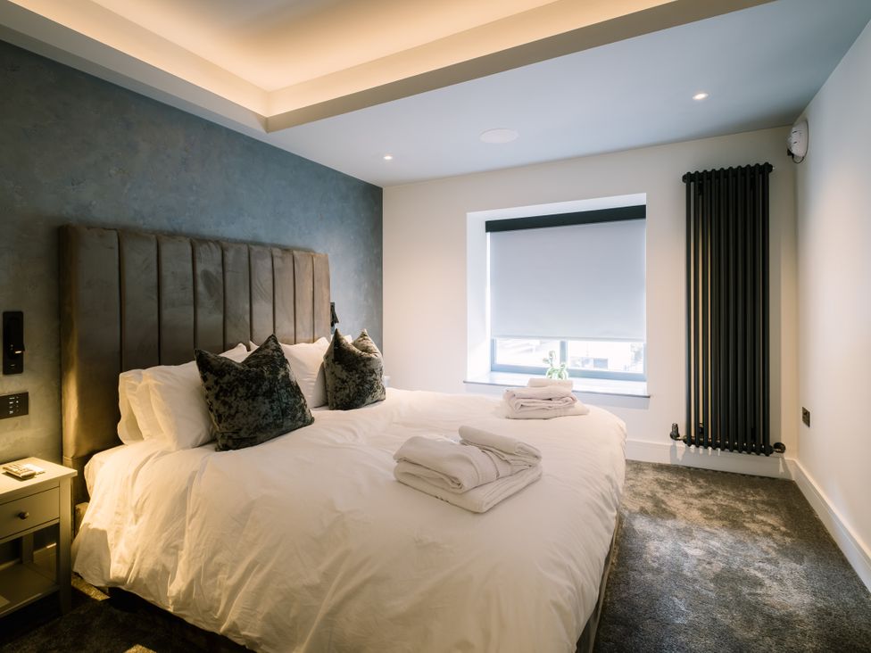 A bedroom with a bed and window at Bounty Boutique on the Lakes Bowness-On-Windermere