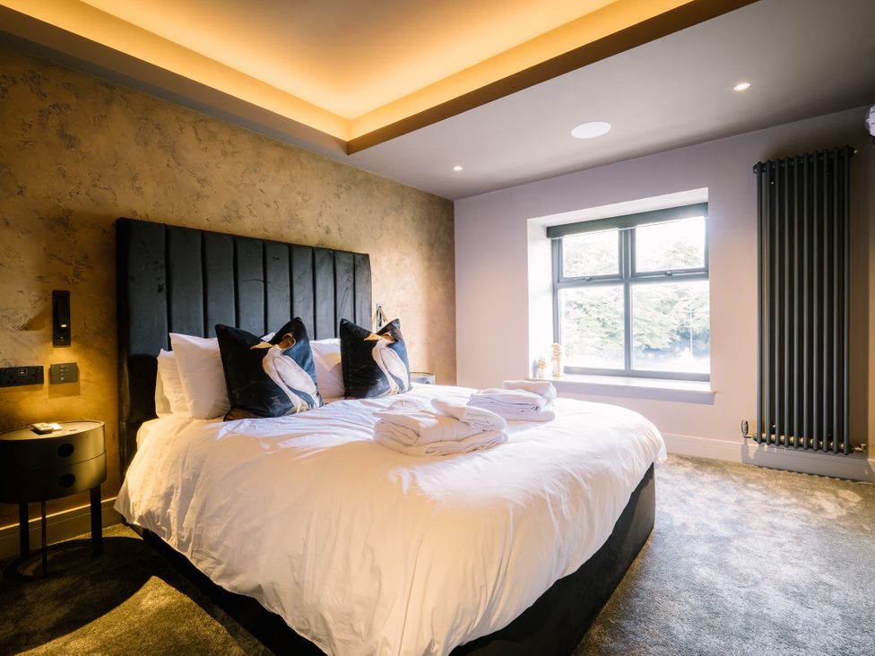 A bedroom with a bed and window at Bounty Boutique on the Lakes Bowness-On-Windermere