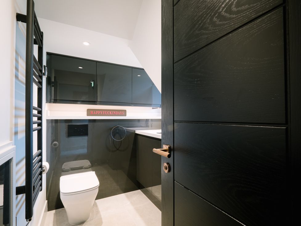 A bathroom with a toilet and sink at Bounty Boutique on the Lakes Bowness-On-Windermere