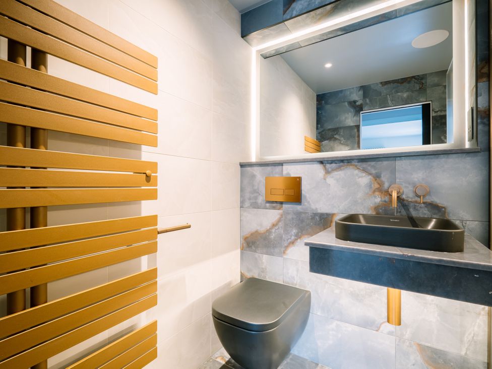 A bathroom with a toilet and sink at Bounty Boutique on the Lakes Bowness-On-Windermere