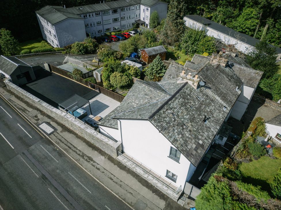 An aerial view of a building with a garden and road at Bounty Boutique on the Lakes Bowness-On-Windermere