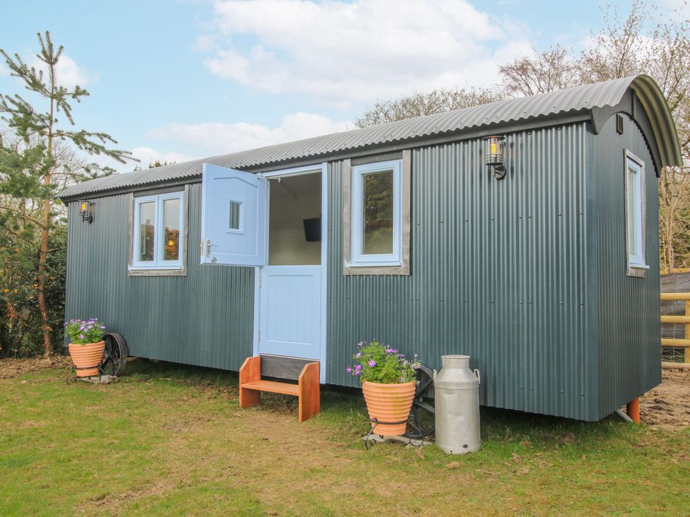 A shelter with blue door and windows set outside at Skye in Clee Hill