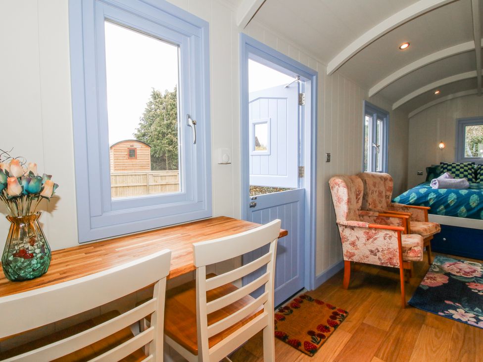 A living room with a table and chairs at Skye in Clee Hill