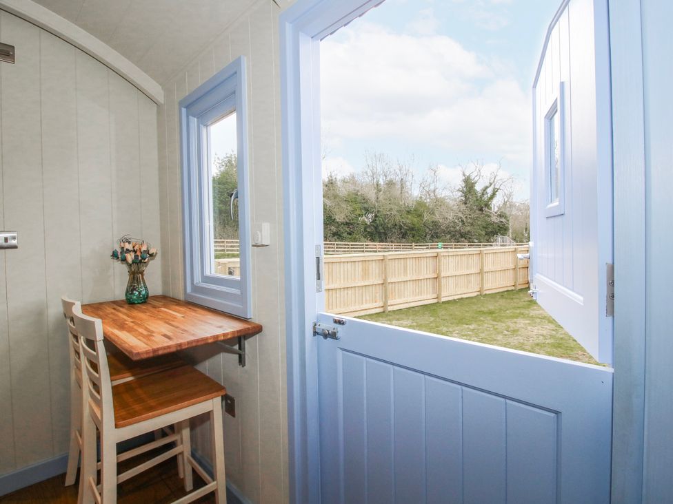 A dining space with a table and chair at Skye in Clee Hill