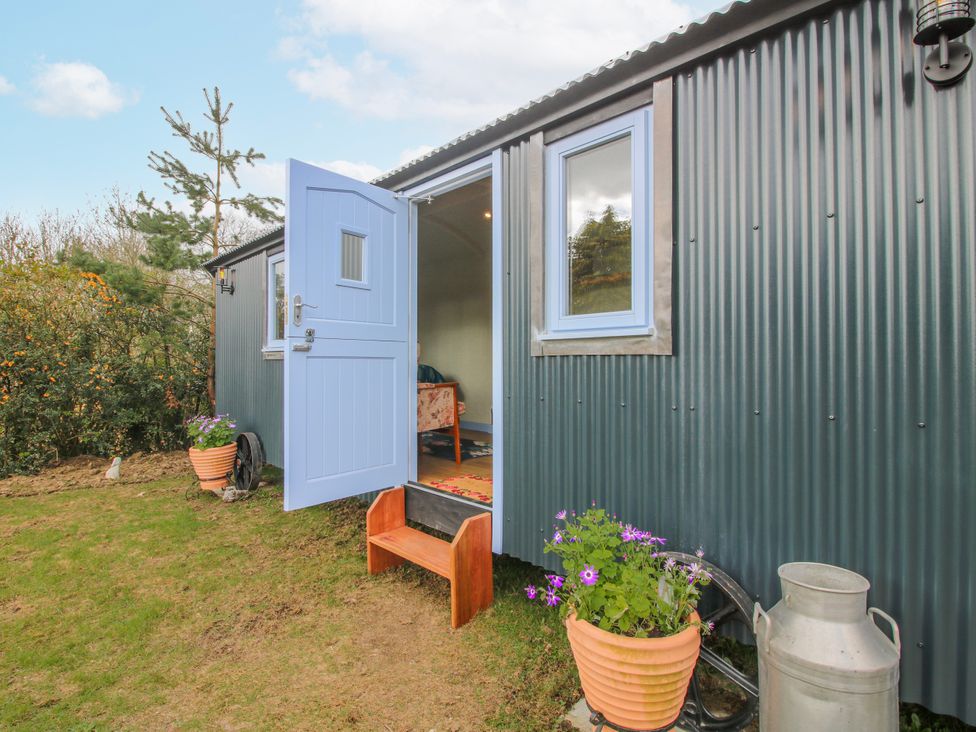 An entrance with a blue door and flowers at Skye Clee Hill