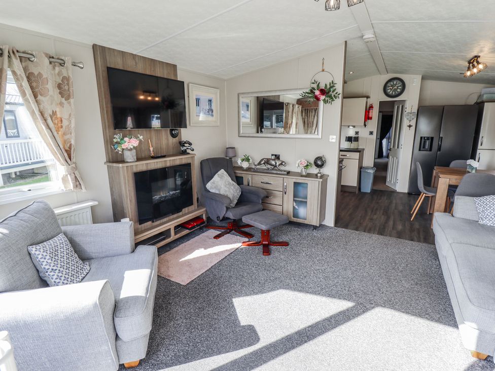 A living room with a television and sofa at 13 The Lakes in Mablethorpe