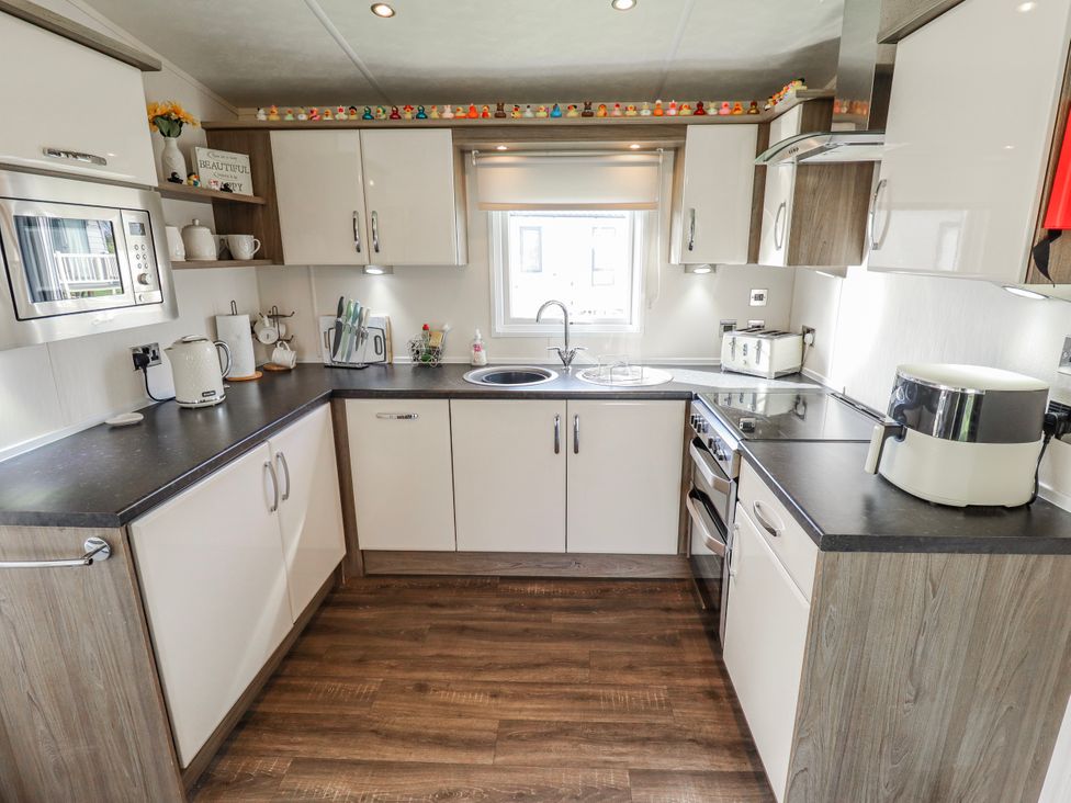 A kitchen with appliances and utensils at 13 The Lakes in Mablethorpe
