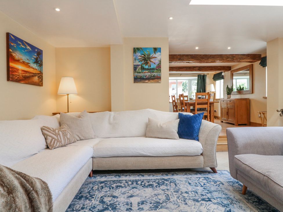 A living room with a sofa and dining area at Brecks Cottage in Moorhouse near Tuxford