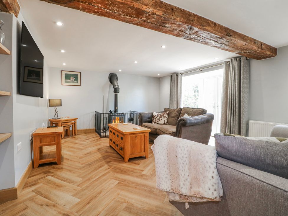 A living room with a fireplace and seating area at Brecks Cottage Moorhouse near Tuxford