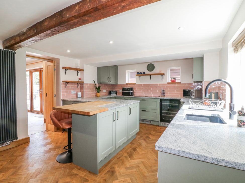 A kitchen with an island and appliances at Brecks Cottage Moorhouse near Tuxford