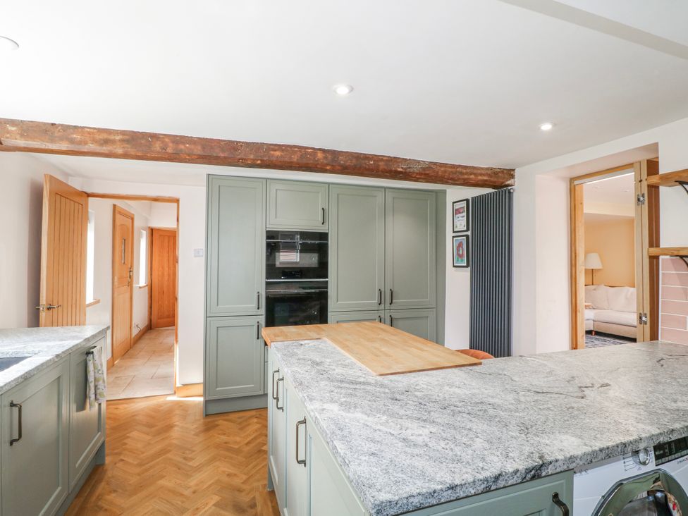 A kitchen with island and appliances at Brecks Cottage Moorhouse near Tuxford