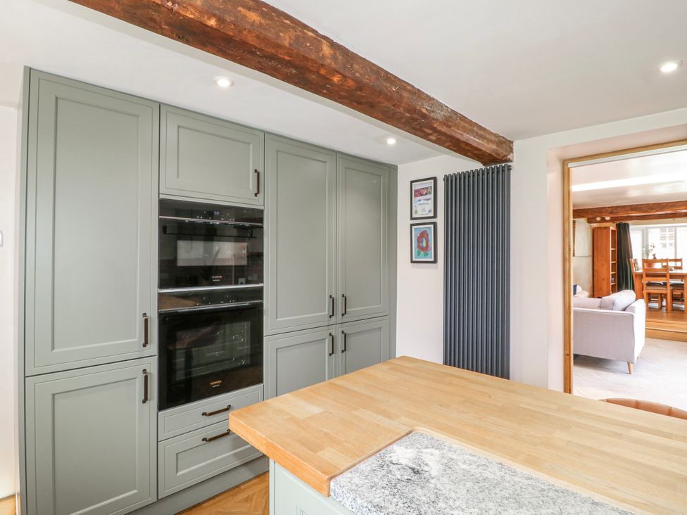A kitchen with cabinets and ovens at Brecks Cottage Moorhouse near Tuxford
