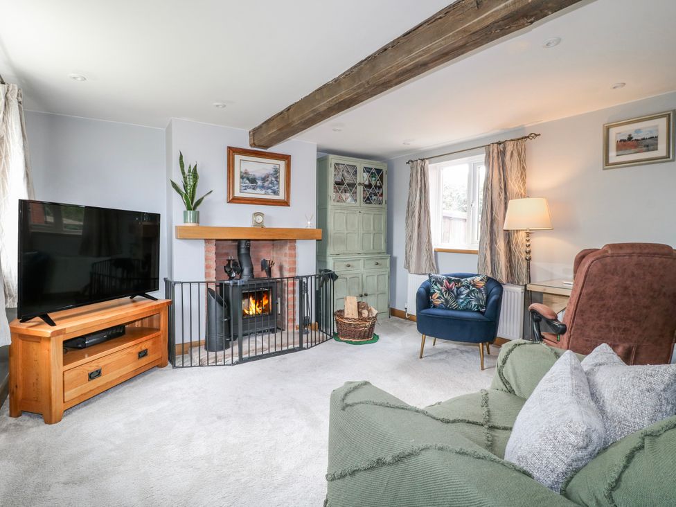A living room with a fireplace and television at Brecks Cottage Moorhouse near Tuxford