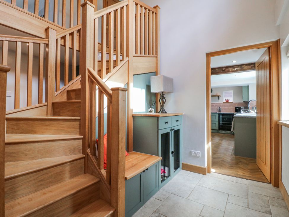 A hallway with stairs and a console table at Brecks Cottage Moorhouse near Tuxford