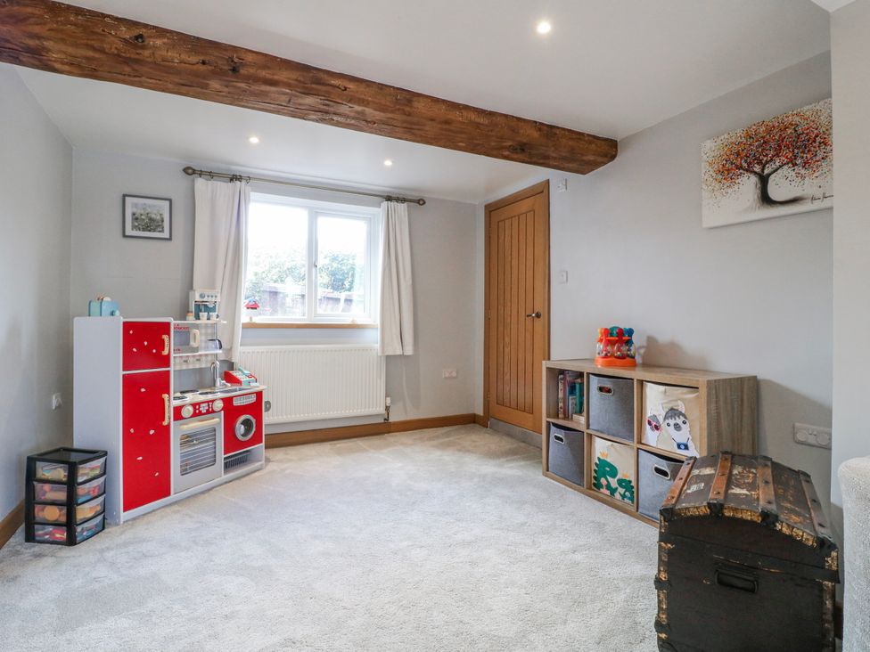 A playroom with a toy kitchen and storage unit at Brecks Cottage Moorhouse near Tuxford