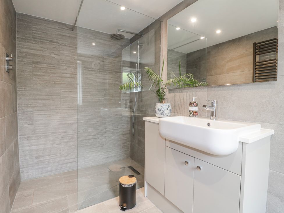 A bathroom with a shower and sink at Brecks Cottage Moorhouse near Tuxford