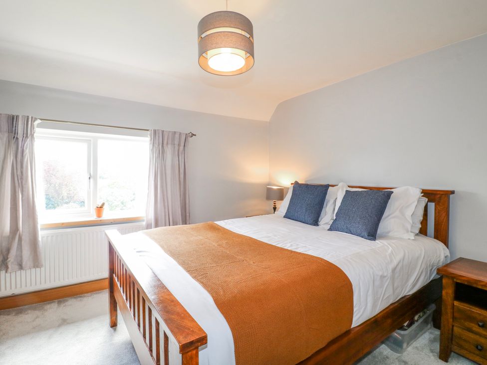 A bedroom with a bed and lamp at Brecks Cottage Moorhouse near Tuxford