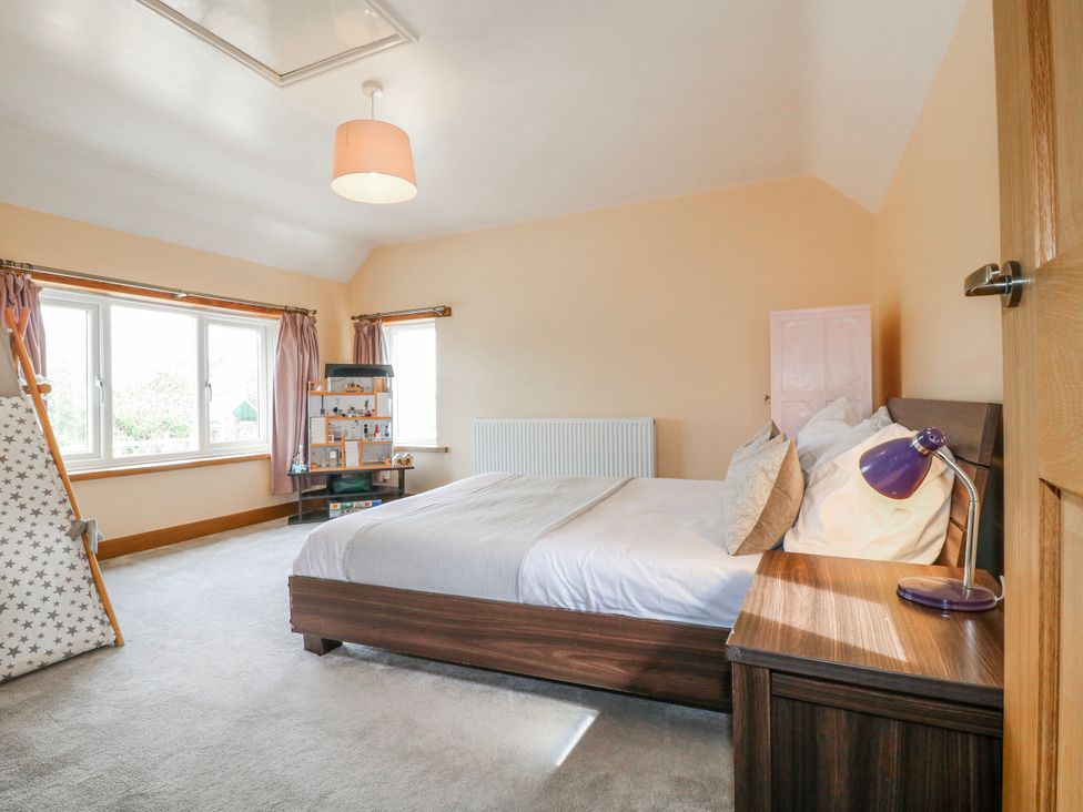 A bedroom with a bed and shelves in Brecks Cottage Moorhouse near Tuxford