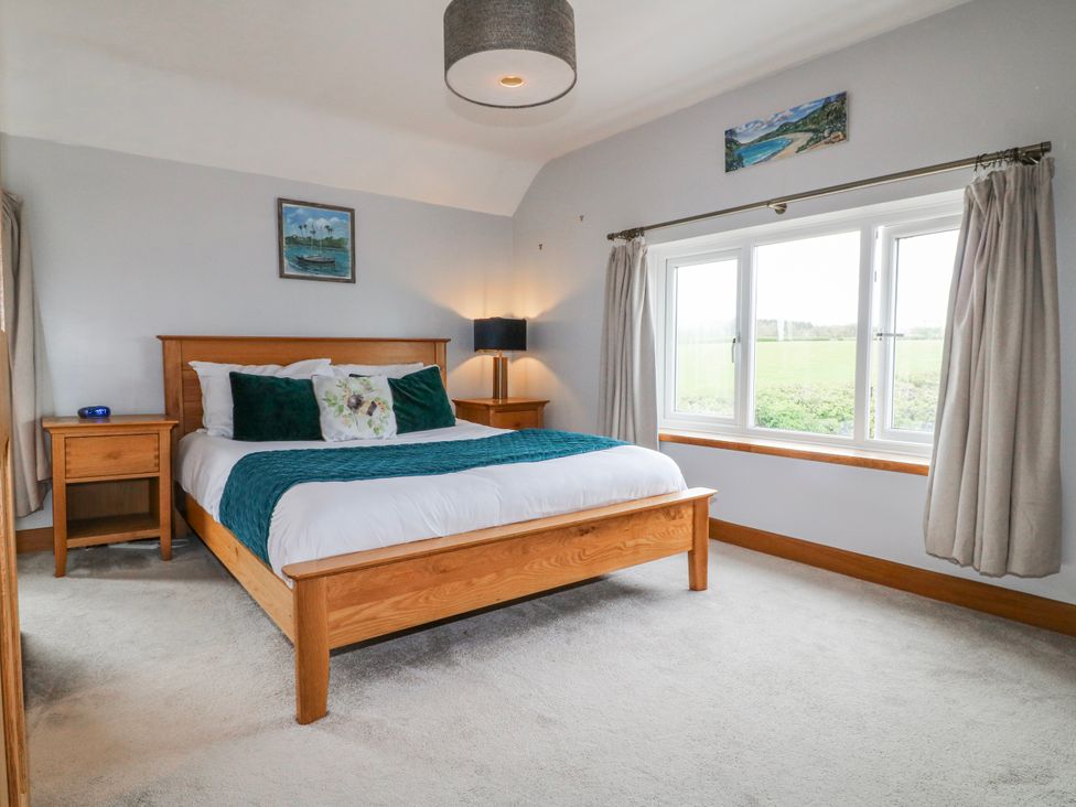 A bedroom with a bed and bedside table at Brecks Cottage Moorhouse near Tuxford