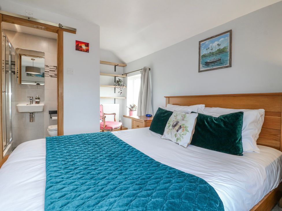 A bedroom with a bed and attached bathroom at Brecks Cottage Moorhouse near Tuxford