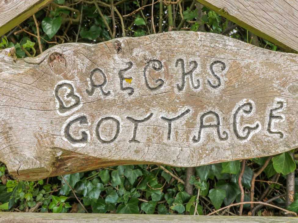 A wooden sign with Brecks Cottage engraved at Brecks Cottage Moorhouse near Tuxford