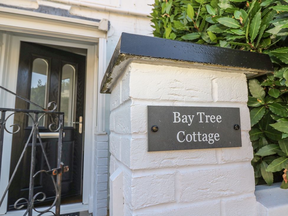 An entrance with a sign and gate at Bay Tree Cottage in Shanklin