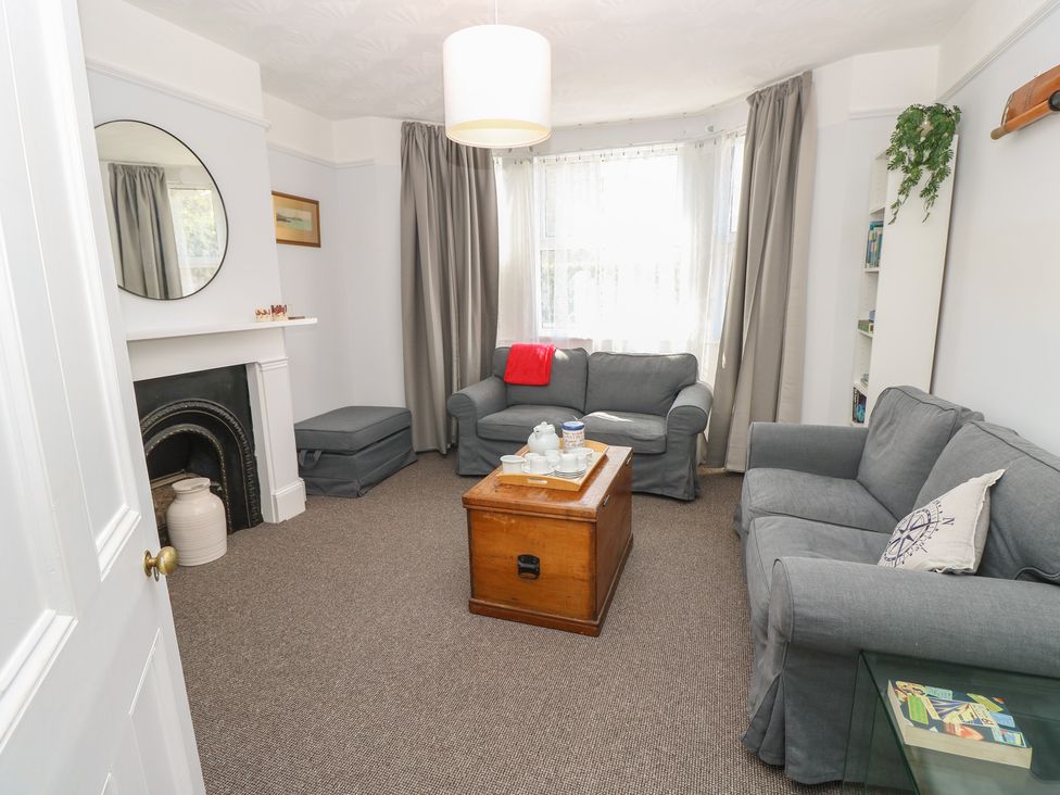 A living room with a coffee table and sofas at Bay Tree Cottage, Shanklin