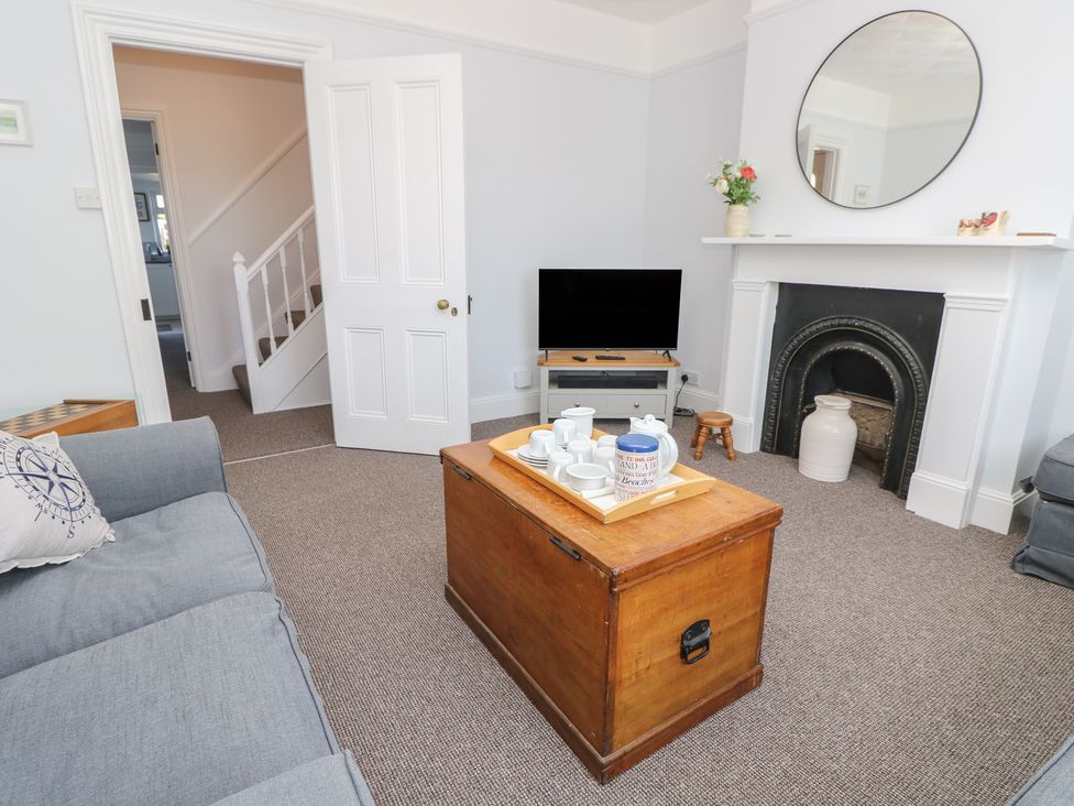 A living room with a television and coffee table at Bay Tree Cottage in Shanklin