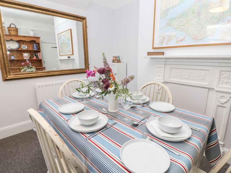 A dining room with a table set for four at Bay Tree Cottage in Shanklin