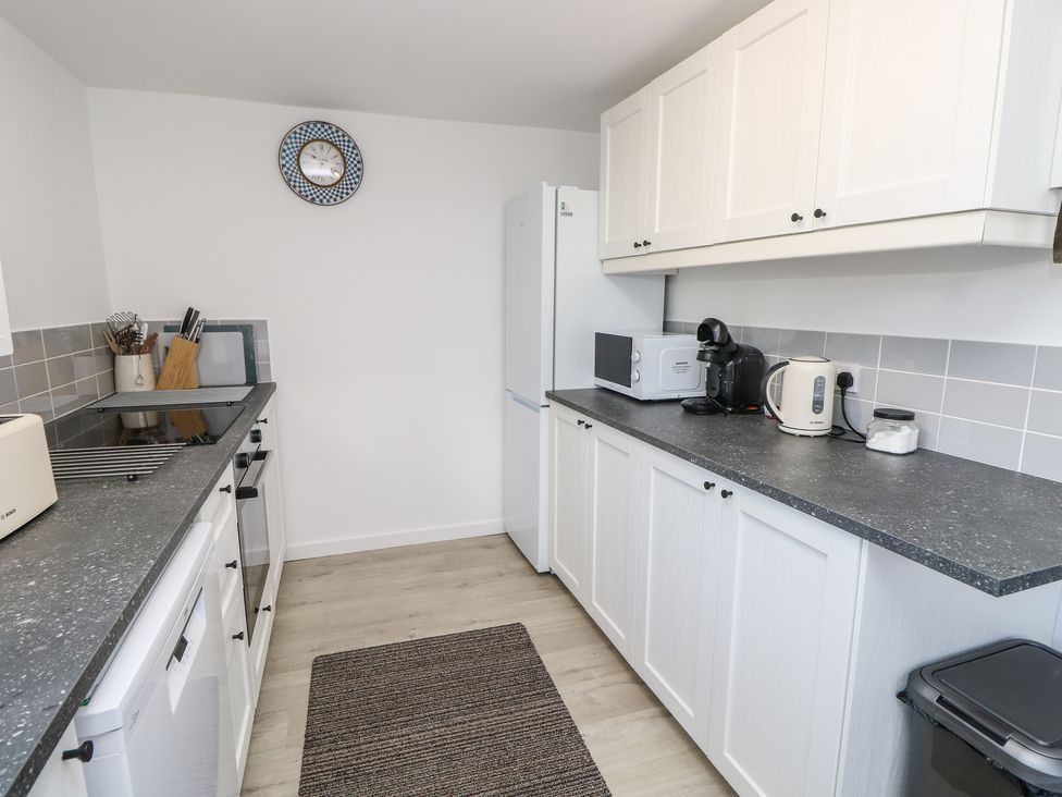 A kitchen with appliances and countertops at Bay Tree Cottage in Shanklin