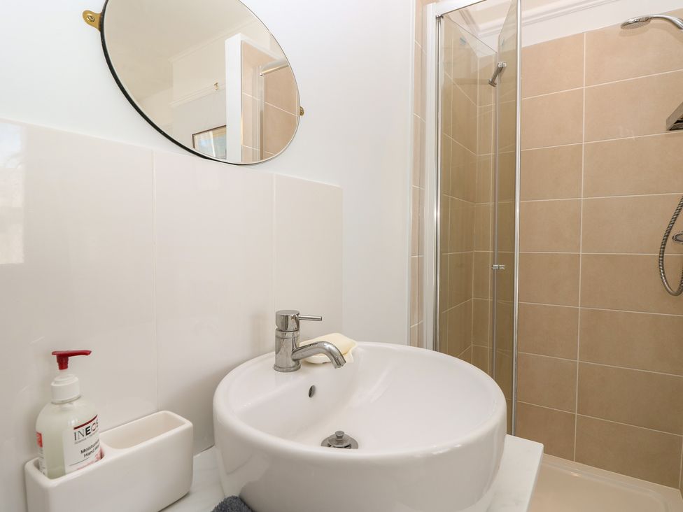 A bathroom with sink and shower at Bay Tree Cottage in Shanklin