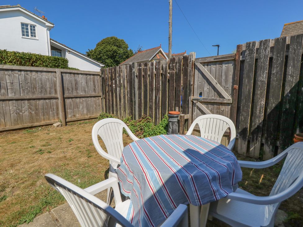 A garden with a table and chairs at Bay Tree Cottage in Shanklin