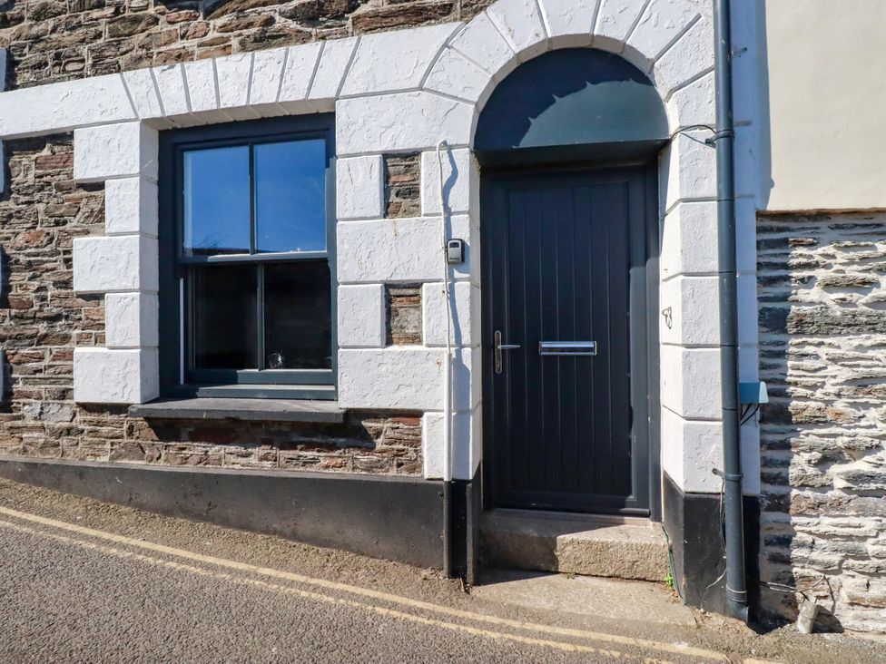An entryway with a door and a window at Whalebone Cottage in St. Austell