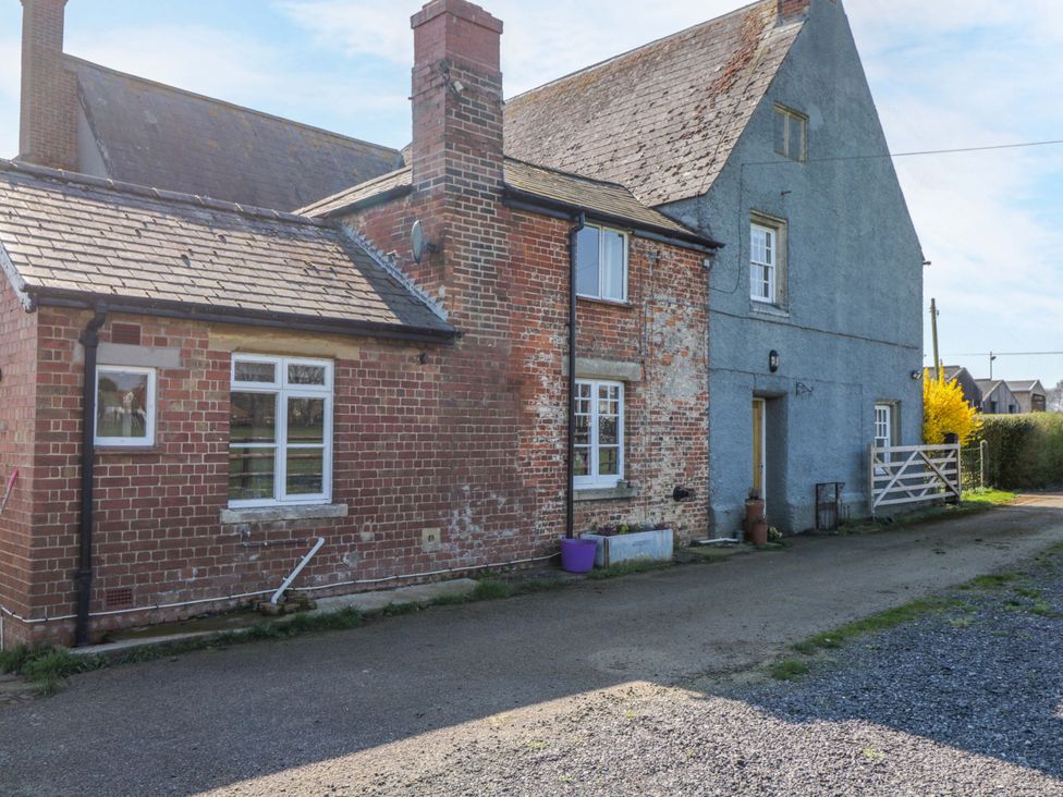 An outdoor view of a house with a driveway at 3 Woods Farm House in Chippenham