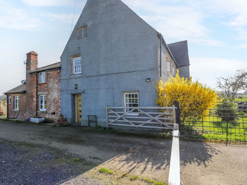 A house with a gate and tree in front at 3 Woods Farm House in Chippenham
