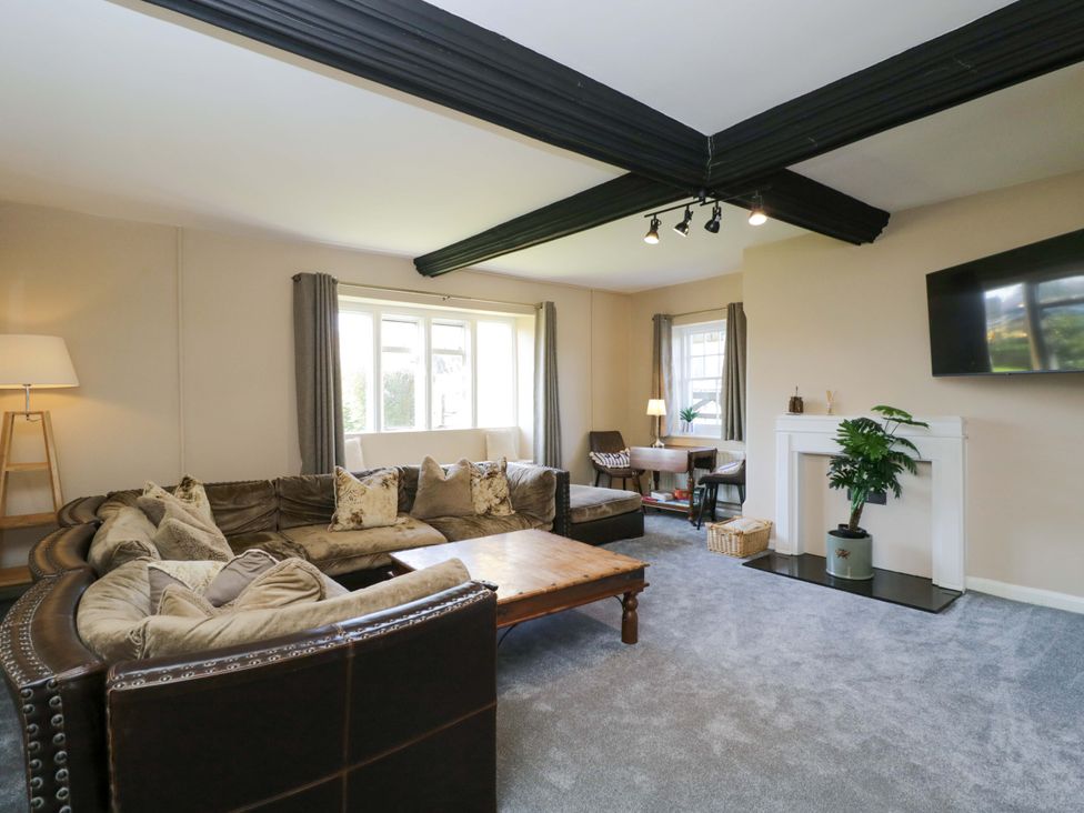 A living room with a sofa and coffee table at 3 Woods Farm House in Chippenham