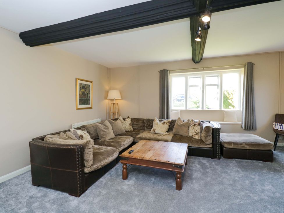 A living room with a sofa and coffee table at 3 Woods Farm House in Chippenham