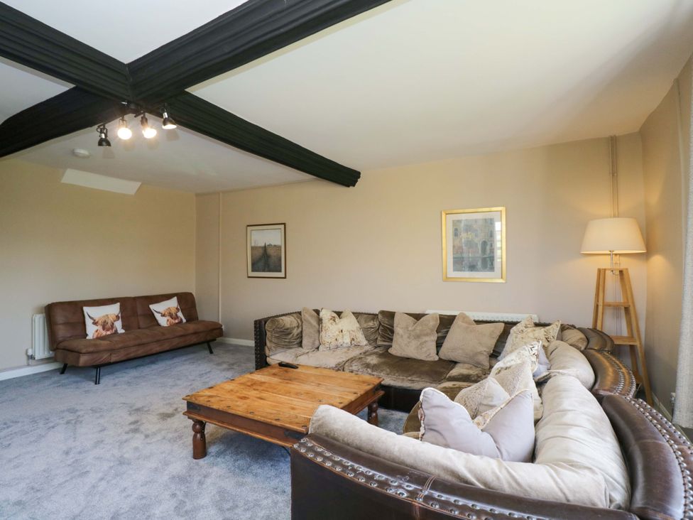 A living room with a sofa and coffee table at 3 Woods Farm House in Chippenham