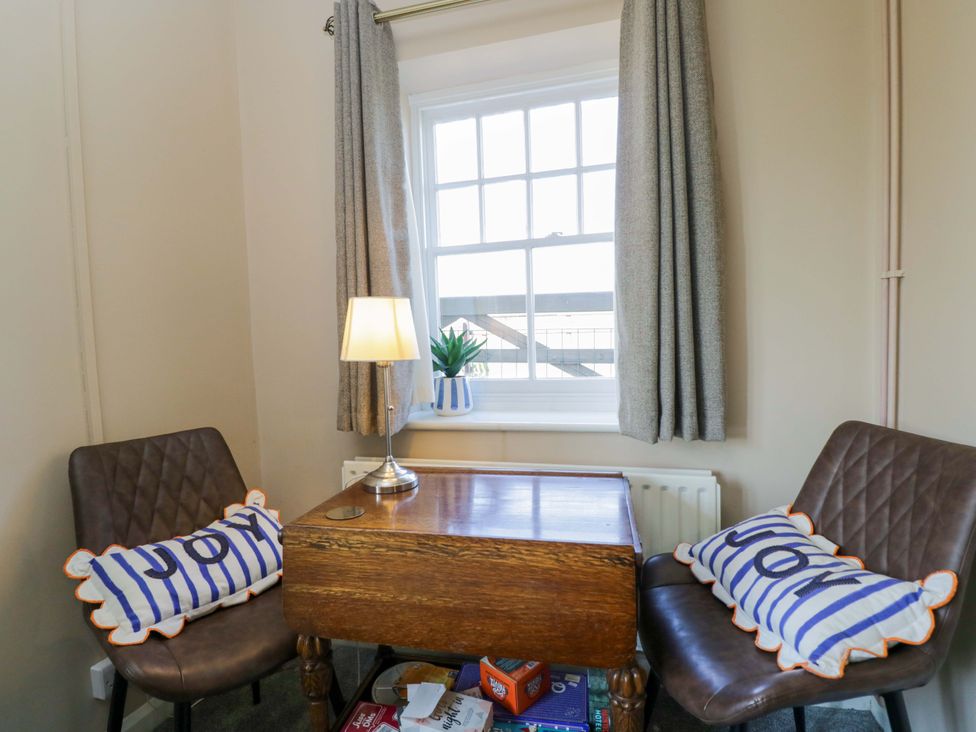 A sitting room with a table and two chairs at 3 Woods Farm House in Chippenham