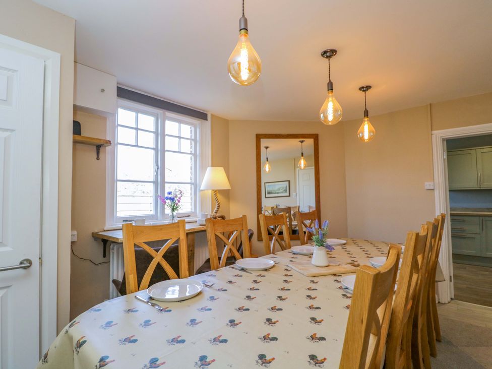 A dining room with a large table and chairs at 3 Woods Farm House in Chippenham
